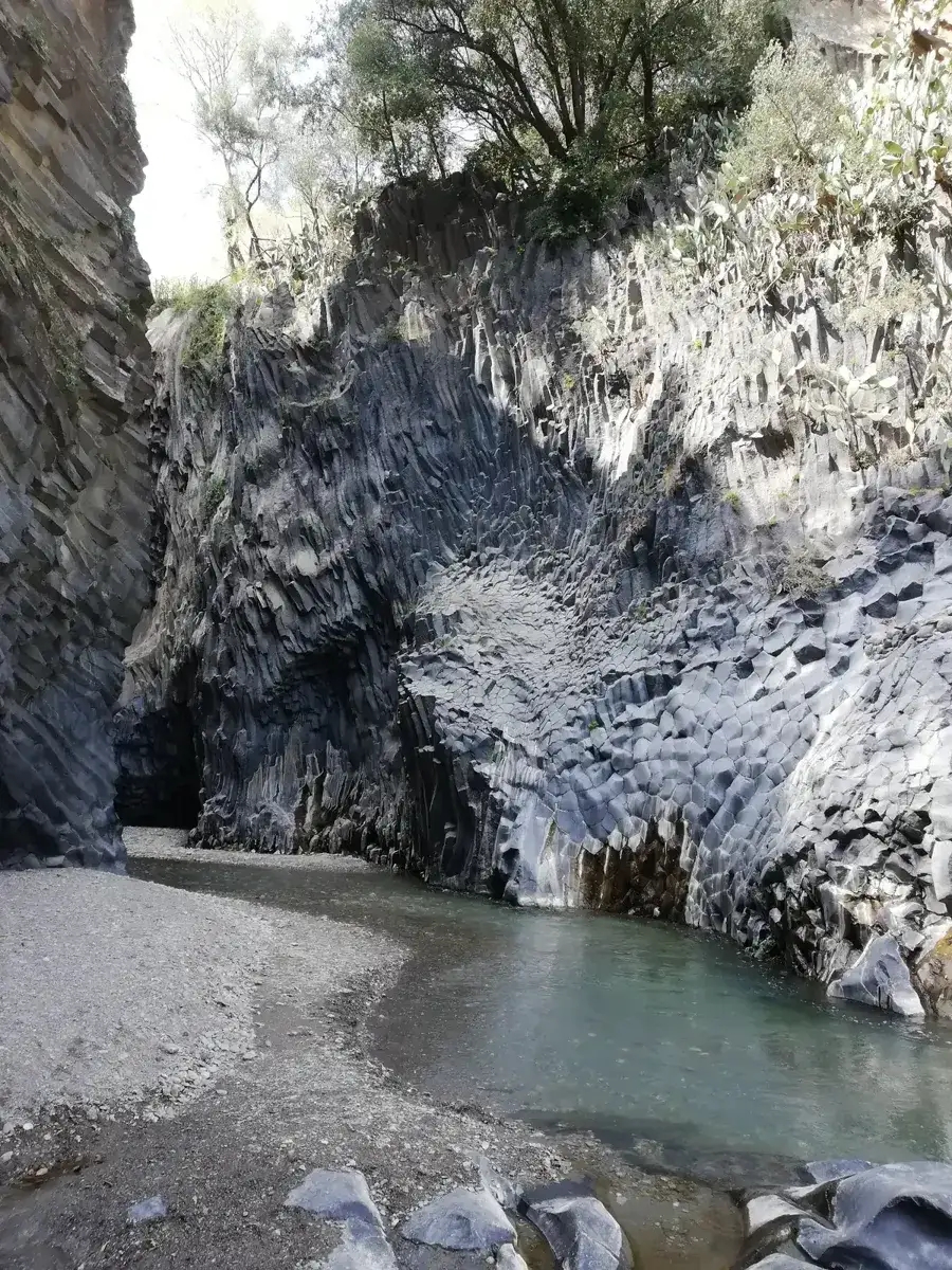 Basalt columns and the river inside the Alcantara Gorges, paired with Mount Etna on tours from Taormina, Sicily