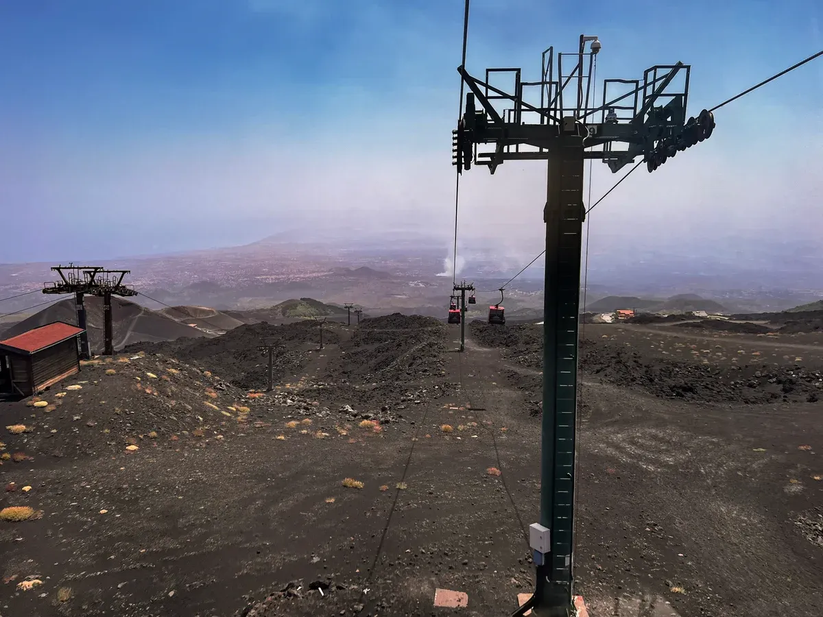 The Funivia dell'Etna cable car above black lava slopes, an extra on Mount Etna tours from Taormina, Sicily